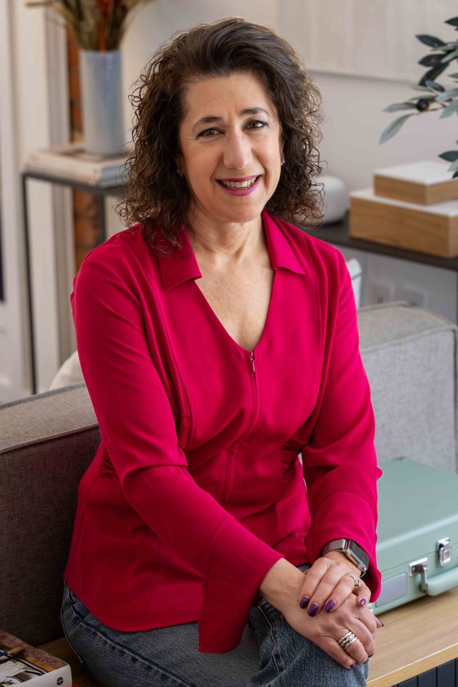 Sara Curwen smiling, seated at home